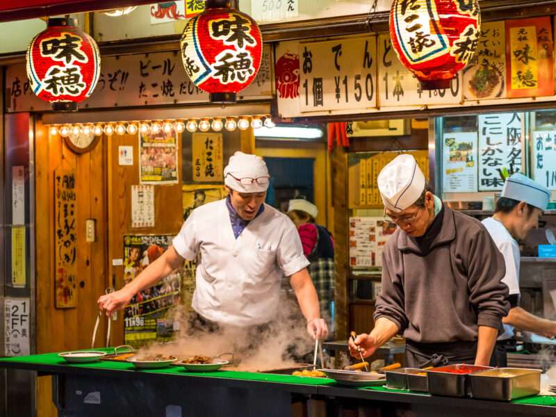 Men cook traditional Japanese street food on December 27, 2014 in Osaka, Japan. (Source: Depositphoto.com)